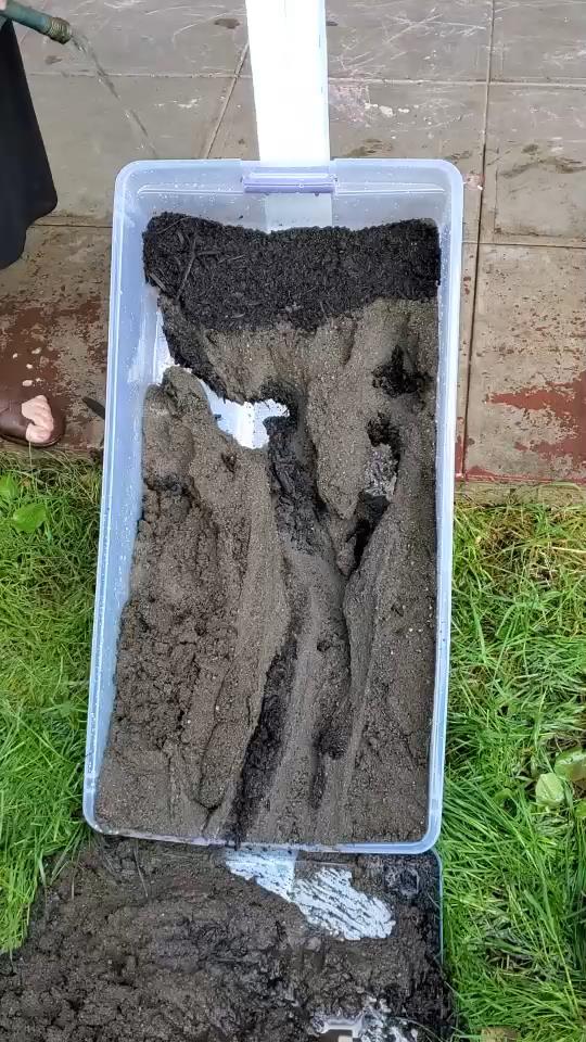 plastic bin full of wet eroding soil