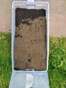 plastic bin full of soil